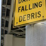Danger Falling Debris sign underneath a skyway.
