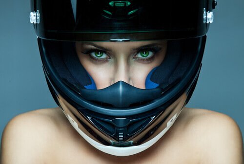 Female with green eyes wearing a helmet.