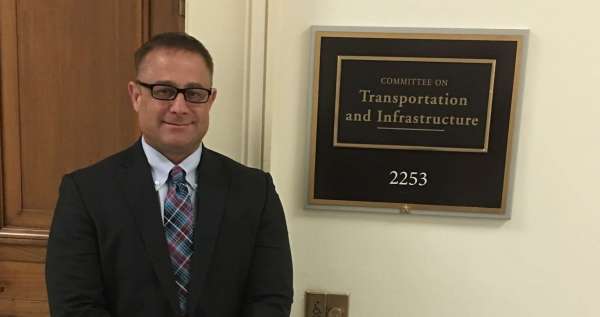 Attorney Michael Ehline pictured in front of the Department of Transportation Hearing Chamber. 1200 New Jersey Ave SE, Washington, DC 20590.