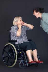Elder abuse senior woman being shouted at by nurse