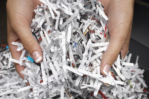 Closeup of female hands with shredded papers