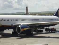 Image of jetliner waiting to load passengers for trip to LAX. Falling luggage is a real threat for brain injuries in these instances.