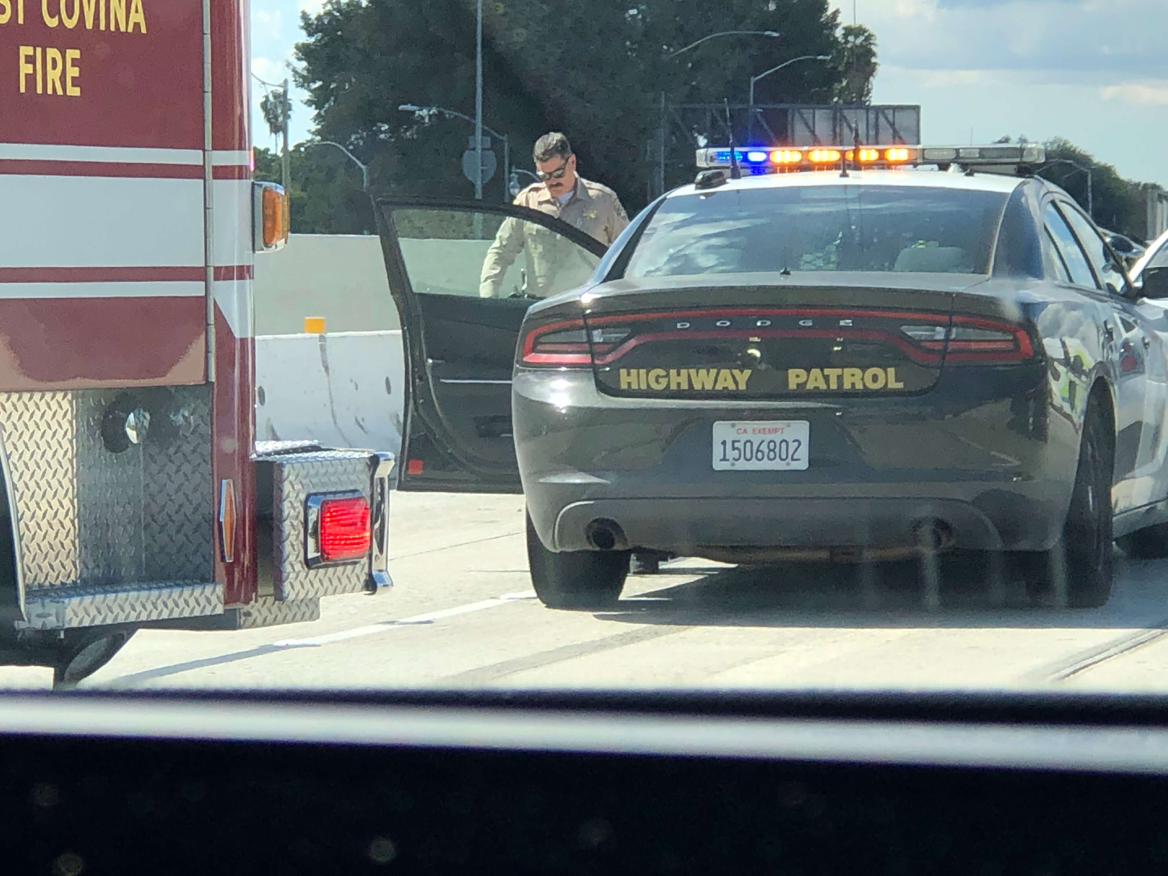 Moustached CHP officer responds to accident scene off of the 10 Freeway.