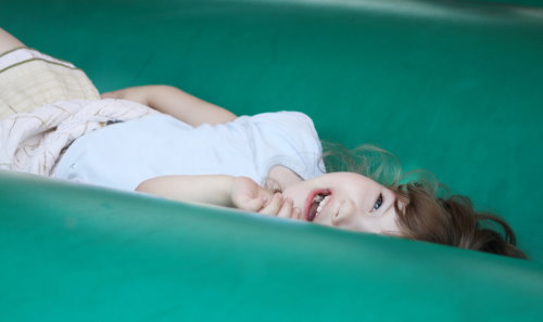 A child having fun in a bouncy house