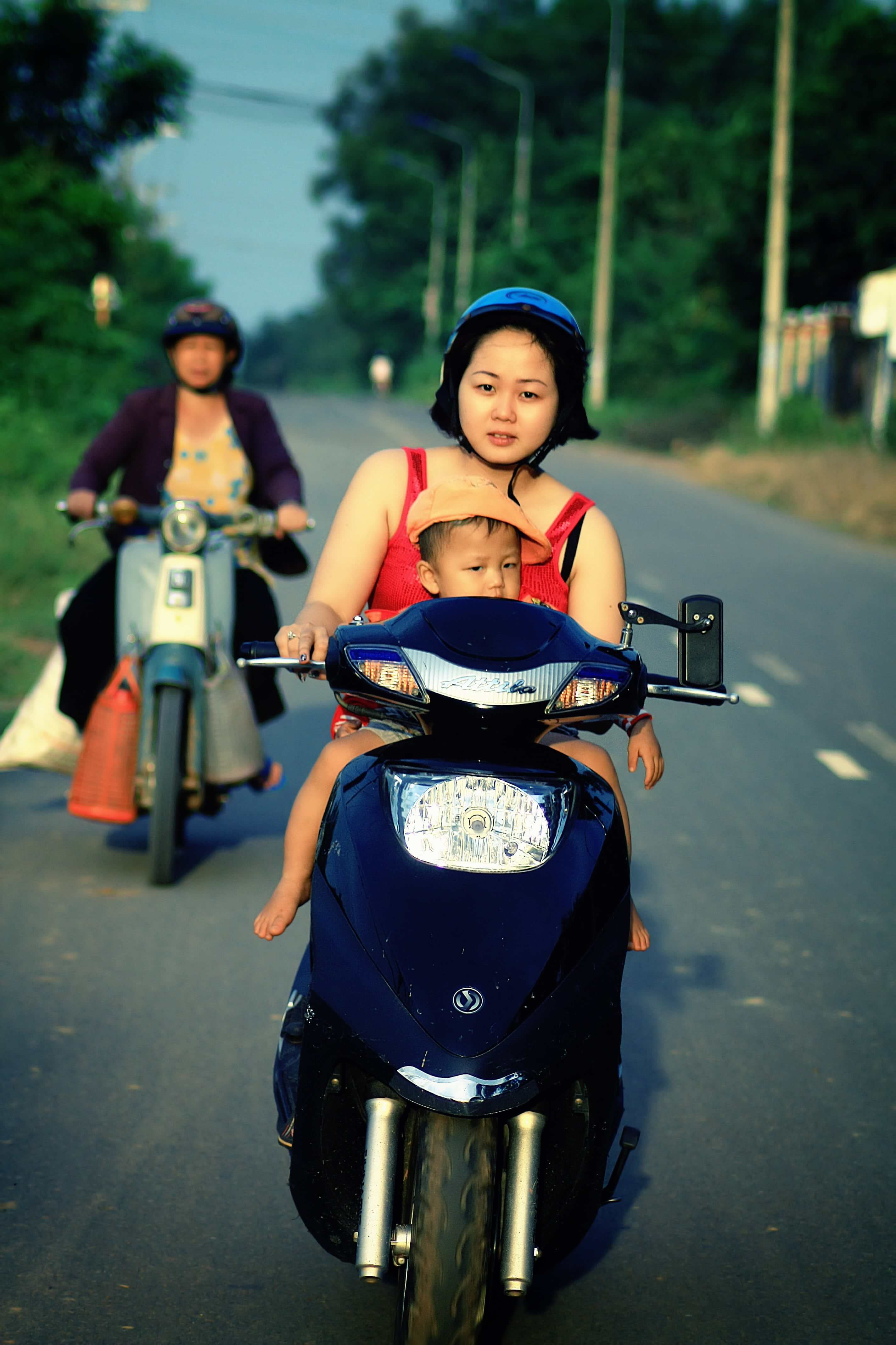 Child riding on front of a motorcycle picture.