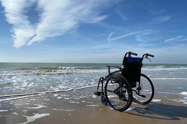 Wheelchair at California Beach. Can a Paralyzed Person Control Their Bowels?