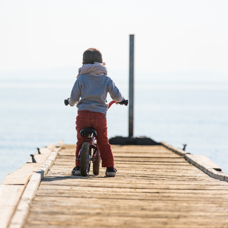 Bicycle rider child at the boat docks