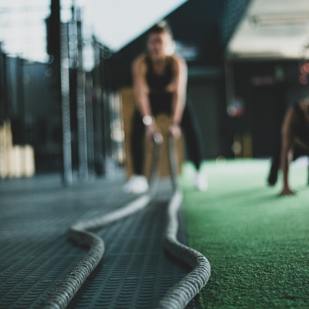 Woman working out with heavry ropes