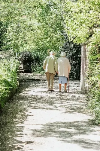 Two seniors with a walking cane